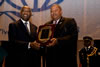His Excellency Mr. Laurent Gbagbo, President of the Republic of Côte d'Ivoire, receiving an "Excellence Leadership Award" from the G-77 Chair, The Honourable W. Baldwin Spencer, Prime Minister and Minister for Foreign Affairs of Antigua and Barbuda.